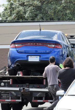A car being loaded onto a flatbed tow truck